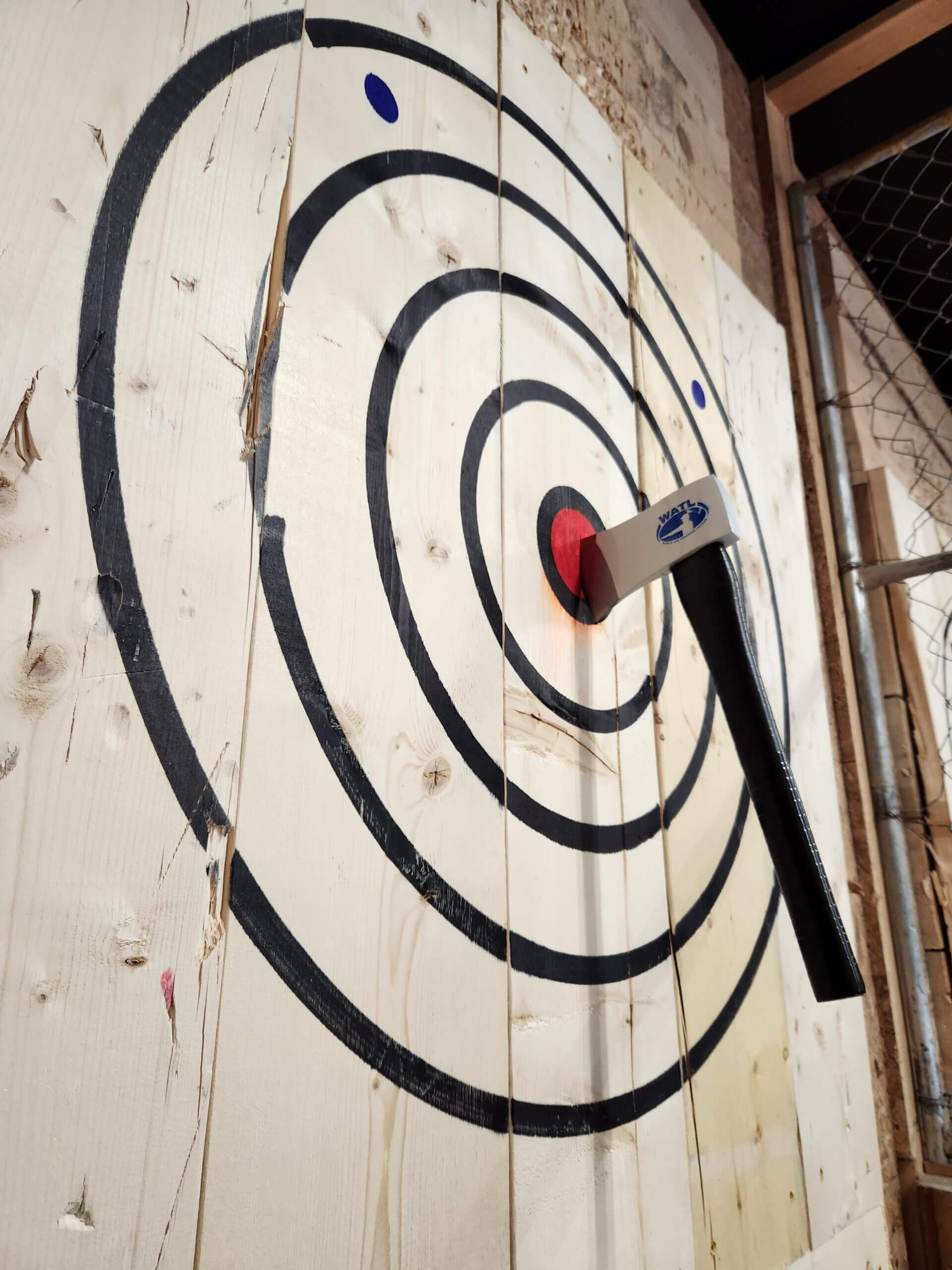 Image of an axe in the bullseye of the target at Deep Creek Axe Throwing Co.